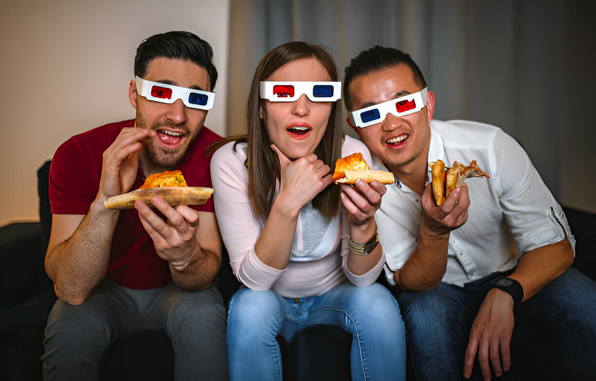 Amigos comiendo pizza mientras ven una película